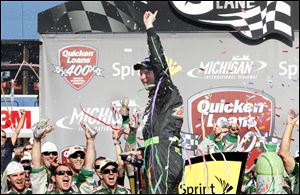 Dale Earnhardt Jr. and his crew celebrate his win on Father's Day during the Sprint Cup Series Quicken Loans 400 race at the Michigan International Speedway on June 18, 2012.