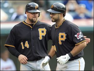 Pittsburgh's Casey McGehee, left, congratulates teammate Pedro Alvarez for hitting a two-run home run off Indians reliever Nick Hagadone in the ninth inning.