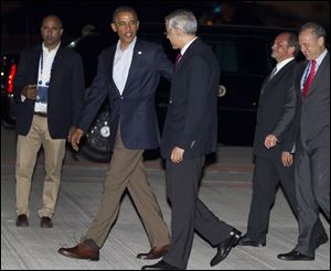 President Barack Obama talks with Ambassador Julian Ventura as he arrives at Los Cabos International Airport to attend the G20 Summit, Sunday.