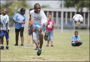 Adrian Michael, 10, kicks a soccer ball at the National Youth Sports Program at the University of Toledo. There were once 200 such summer programs across the country, but Toledo's is one of 31 remaining.