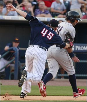 Toledo Mud Hens pitcher Casey Crosby tags out Lehigh Valley IronPigs left fielder Jason Pridie during the fifth inning Wednesday. Toledo lost 2-1.