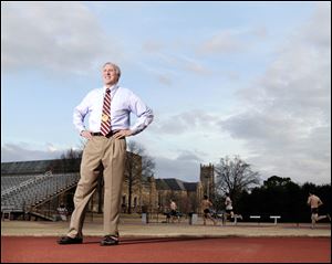 Dave Wottle, standing on the track at Rhodes College in Memphis, wears the gold medal he won in the 800 meters at the 1972 Olympics.