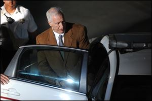 Jerry Sandusky leaves the courthouse after being convicted of 45 of 48 counts of child sexual abuse on Friday.
