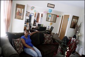 Stacy Madden, 35, poses in the living room of her 2-year-old home which was developed by the United North Community Development Corp.