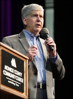 Michigan Governor Rick Snyder appears at a public hall town meeting at the Monroe County Community College La-Z-Boy Auditorium in Monroe, Mich.