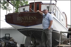 Scott Market shows off ‘Restless,' a 1938 tugboat his family uses for tours of the Lake Erie islands for as many as six passengers.

