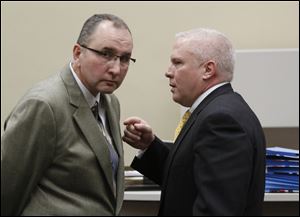 Robin Horvath, left, confers with lawyer Troy Moore following a hearing on the sale of Tony Packo's restaurants to Bob Bennett, in Lucas County Common Pleas Court in December 2011.