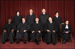 Supreme Court Justices from back left: Sonia Sotomayor, Stephen Breyer, Samuel Alito Jr., and Elena Kagan. Front from left: Clarence Thomas, Antonin Scalia, John Roberts (chief justice), Anthony M. Kennedy, and Ruth Bader Ginsburg. The court's four liberal justices, Stephen Breyer, Ruth Bader Ginsburg, Elena Kagan and Sonia Sotomayor, joined chief justice John Roberts in voting to uphold Obama's health care law. Justices Samuel Alito, Anthony Kennedy, Antonin Scalia and Clarence Thomas dissented.