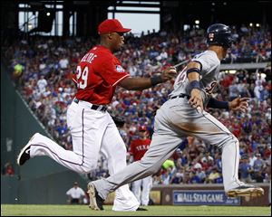 Texas Rangers third baseman Adrian Beltre (29) tags out Detroit Tigers' Quintin Berry (52) on a rundown in the fifth inning in Arlington, Texas, Wednesday.