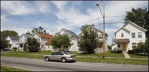 Of the six homes in the 2200 block of Kent Street, only the home owned by Zettie Williams, second from left, is occupied.  The homes were developed as tax credit properties by the Warren Sherman Area Council.  