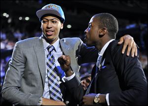 Kentucky's Anthony Davis, left, is congratulated by former teammate Michael Kidd-Gilchrist, right, after Davis was selected the No. 1 overall draft pick by the New Orleans Hornets in the NBA basketball draft. Kidd-Gilchrist was selected No. 2 overall by the Charlotte Bobcats. 