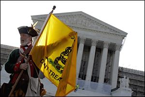 Outside the Supreme Court Thursday, Tea Party supporter William Temple of Brunswick, Ga., stood in opposition to the health-care law,  which conservatives see as excessive government encroachment.