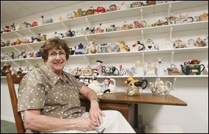 Nancy Kelly collects teapots in the shapes of characters and figures. She has about 100 teapots in the shapes of animals, flowers, buildings, pumpkins, lighthouses, and sundials.