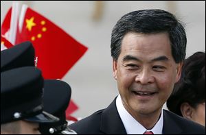 Hong Kong's new Chief Executive Leung Chun-ying smiles during the flag raising ceremony to mark the 15th anniversary of the Hong Kong handover to China in Hong Kong on Sunday. Leung was sworn in on Sunday amid a rising tide of public discontent over widening inequality and lack of full democracy in the semiautonomous southern Chinese financial center.