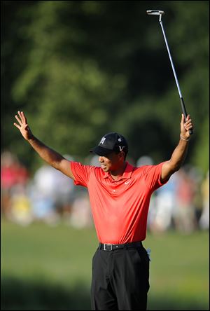 Tiger Woods reacts after sinking the winning putt on the 18th green to capture the AT&T National title. He was dominant all weekend, at one point going 41 holes without a bogey. It was the 74th PGA win of his career, which moved him past Jack Nicklaus into second place on the all-time list.