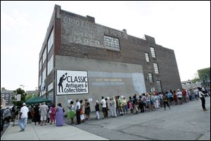 A line of people wait to get tickets for Obama's upcoming visit to Maumee at the Obama campaign office in Toledo. 