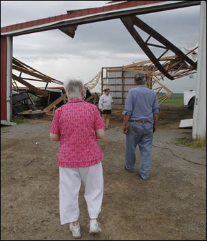 Darlene and Richard Williams, with their daughter Michele,
inspect their barn in Mount Cory, Ohio.