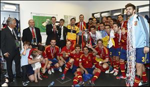 Spain's Crown Prince Felipe, top center, and Spain's Prime Minister Mariano Rajoy, top 3rd from left, join Spain's victorious soccer team in Kiev, Ukraine. Spain beat Italy 4-0 in the Euro 2012 soccer final.