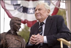 Andy Griffith sits in front of a bronze statue of Andy and Opie from the 'Andy Griffith Show,' in Oct., 2003. A North Carolina TV station is reporting that the actor has died.