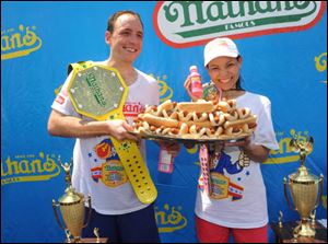 Joey Chestnut and Sonya Thomas celebrate together after their wins at the Nathan’s Famous Fourth of July International Hot Dog Eating Contest last year.
