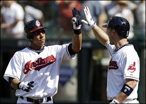 Cleveland Indians' Michael Brantley, left, is greeted by Jack Hannahan after Brantley's three-run home run off Los Angeles Angels starting pitcher Ervin Santana in the first inning Wednesday.