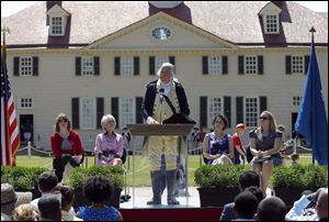 A re-enactor portraying Gen. George Washington speaks to candidates for naturalization during a naturalization ceremony at George Washington's Mount Vernon estate, Wednesday.