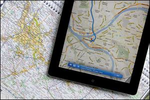 A traditional road map and an iPad both show the Pittsburgh area. Transportation agencies around the country are printing fewer maps because demand is down.
