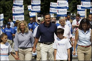 Republican presidential candidate, former Massachusetts Gov. Mitt Romney, his family and Sen. Kelly Ayotte (R., N.H.), right, participate in the Fourth of July Parade in Wolfeboro, N.H.