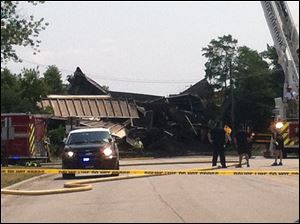 Police investigate the scen of a train derailment in Northbrook, Ill. on Wednesday. A Union Pacific spokesman says a freight train derailed and a bridge over a stretch of road has collapsed in the northern Chicago suburbs. 