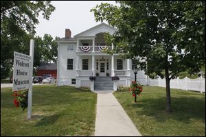 The Wolcott House Museum in Maumee was spruced up for President Obama's visit and will welcome him today with red, white, and blue bunting and cascades of purple petunias, accented with American flags. 