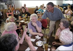 President Obama chats with diners at Kozy Corners in Oak Harbor, Ohio. Customers said Mr. Obama stopped at tables to shake hands and sign autographs, and he ate a cheeseburger, fries, and strawberry pie with extra cream.