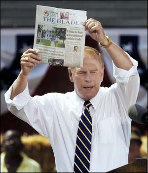 Former Ohio Gov. Ted Strickland shows a copy of Thursday’s
edition of The Blade, noting the President’s plans to file an international trade case against China.