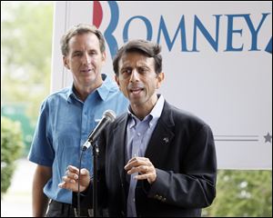 Gov. Bobby Jindal of Louisiana speaks to about 20 people in front of the Courtyard by Marriott in Maumee as former Gov. Tim Pawlenty of Minnesota listens. 