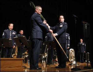 Brig. Gen. Mark Bartman, left, and Maj. Matthew Zelnik decommission the 555th Air Force Band, also known as the Air National Guard Band of the Great Lakes, at Anthony Wayne High School.