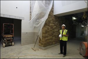 Alan Bacho, director of facilities and operations for the Sylvania system, surveys construction progress from a hallway of the new school.
