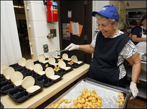 Barbara Walters prepares lunches at the Bedford Senior Center. The center is to move this year from Samaria Road to the former Smith Road Elementary.