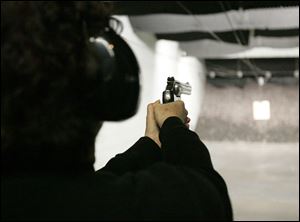 A woman who refused to be identified fires her .22 at the target. She has been shooting about two years and plans to take the concealed carry permit class and wants to get a larger caliber handgun.