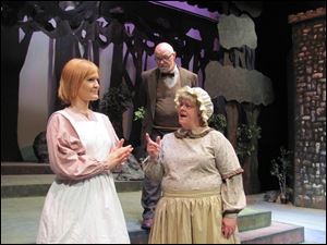 In the Archbold community Theatre production of 'Into the Woods,' the Narrator, played by Ken Bower, observes a scene with Carissa McCurdy, left, and Karen Bower.