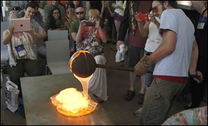 An artisan pours molten glass in a demonstration at the
Toledo Museum of Art’s Glass Pavilion