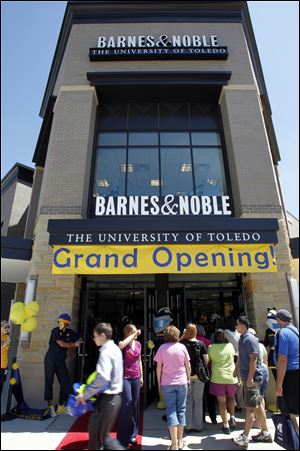 People crowd in front of the two-story, 18,000-square-foot store that will consolidate and replace university bookstores. It anchors the $12 million strip on Dorr Street and Secor Road. The secondary anchor will be a sports bar owned by former UT football star Bruce Gradkowski. 