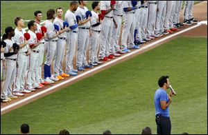 Country singer Luke Bryan performs the national anthem before the 83rd MLB All-Star Game at Kauffman Stadium on Tuesday in Kansas City. He had written lyrics to the song on his hand so he wouldn’t ‘mess up.’