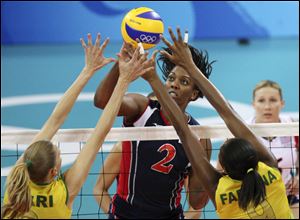 Danielle Scott-Arruda of the U.S. spikes against Brazil in the gold medal volleyball match at the 2008 Beijing Olympics. The 39-year-old from Baton Rouge is headed to her fifth Olympic Games.