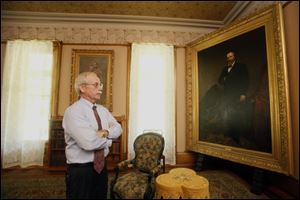 Thomas Culbertson, executive director of the Rutherford B. Hayes Presidential Center, admires a painting in the Hayes home.