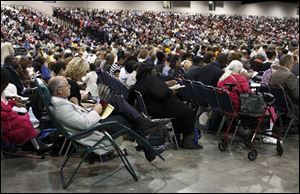 Thousands listen to a speaker during the convention. The theme of the conference is 'Safeguard Your Heart!' based on Proverbs 4:23. 