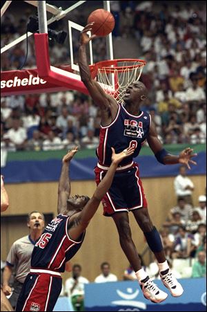 Michael Jordan soars above teammate Magic Johnson at the 1992 Barcelona Games.