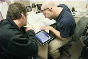 Flight student Don Coburn, left, from Sylvania, and Suburban Aviation, Inc. Flight Instructor Nick Zink, right, joke about the turbulent air while talking about their  flight plan.