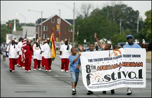 Marchers kick off the 8th annual African-American Festival by stepping down Dorr Street. The two-day festival that began Saturday celebrates the history, culture, heritage, and arts of the African-American community.
