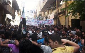 Syrians chant during a demonstration in Damascus in this picture taken by an anonymous photographer. A partial translation of Arabic on the banner is 