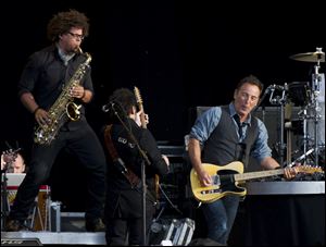 Bruce Springsteen performs with Jake Clemons, left, nephew of late E Street Band member Clarence Clemons. Paul McCartney joined Springsteen for the last two songs. 