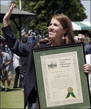 Jennifer Capriati waves during the Tennis Hall of Fame induction ceremonies. She won three major titles.